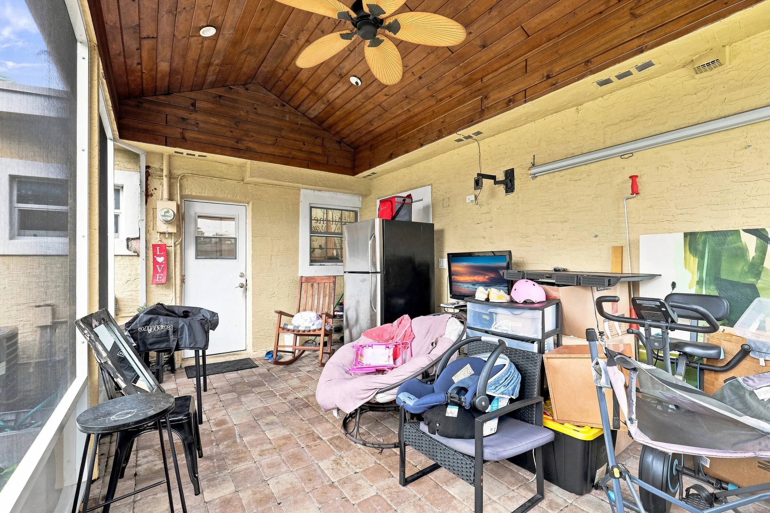 Spacious covered outdoor area with a wood-plank ceiling and plenty of room for seating and entertaining.