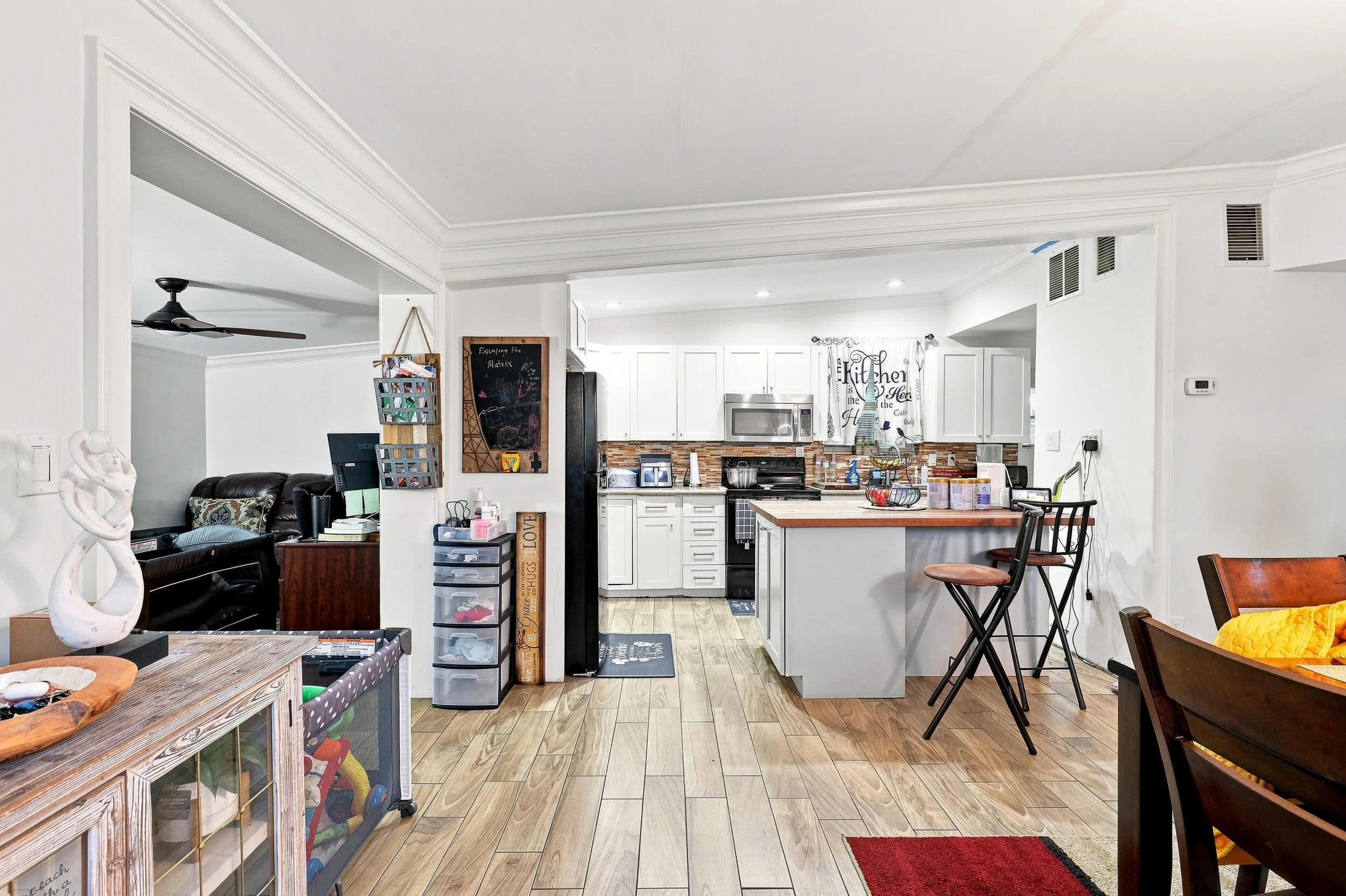 Bright open-concept interior connecting the living, dining, and kitchen spaces.