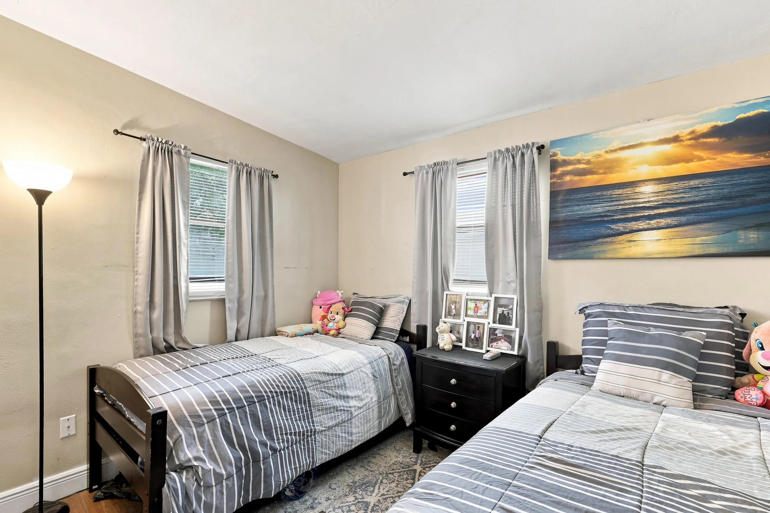 Bright secondary bedroom with space for multiple beds or flexible furniture placement.