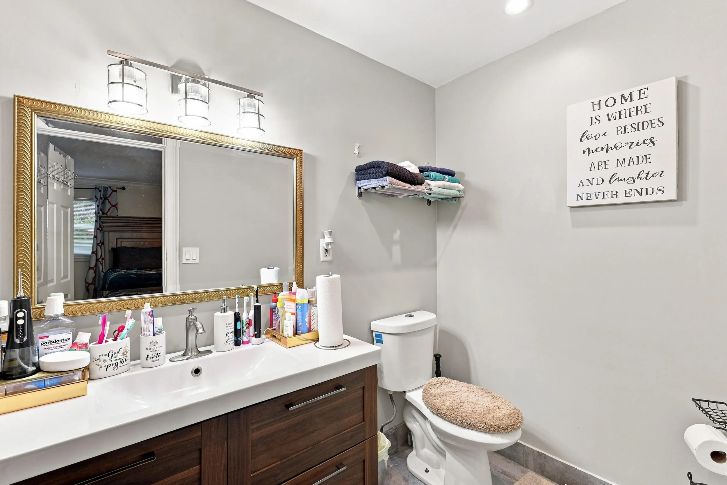 Updated bathroom featuring a spacious vanity, large mirror, and contemporary finishes.