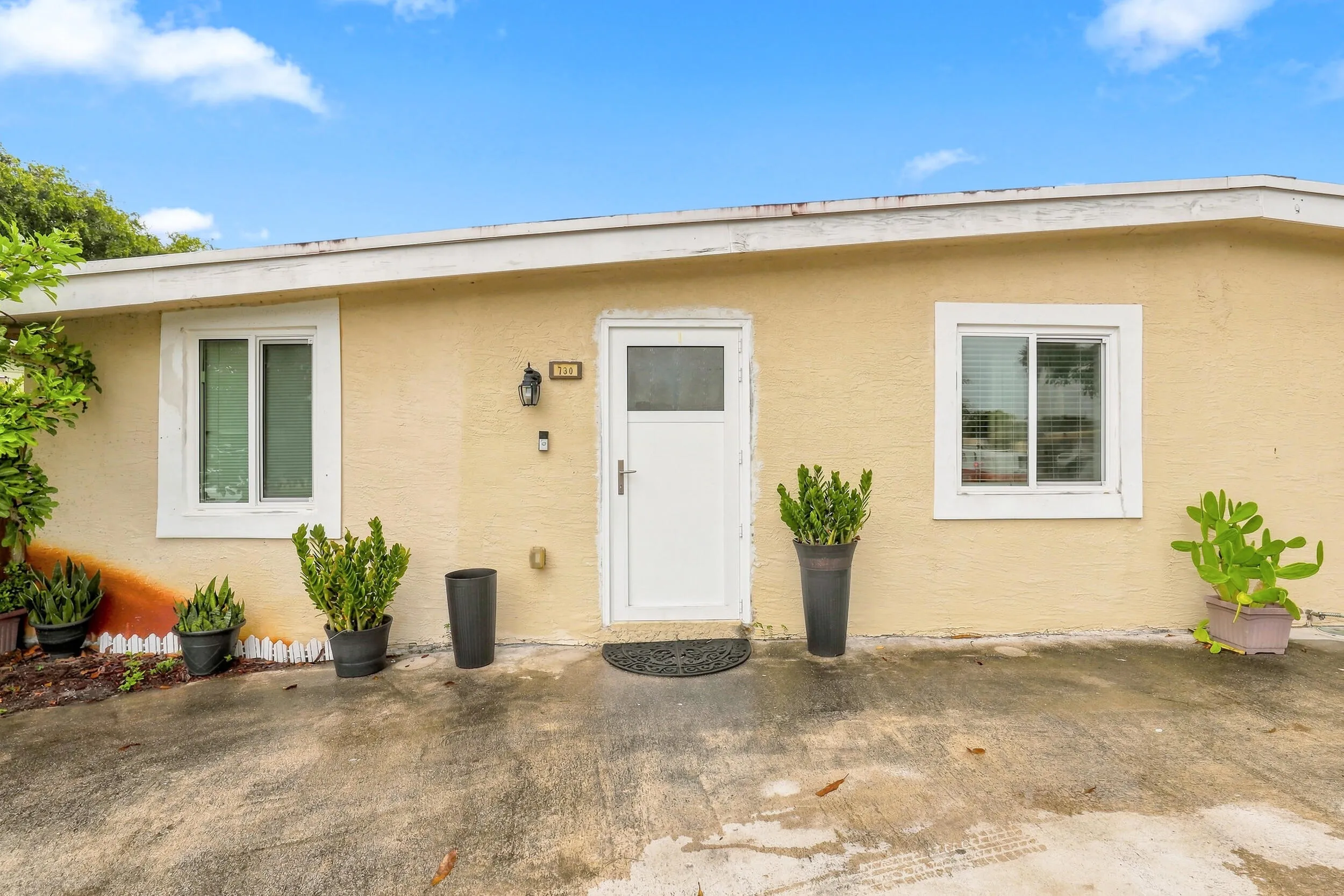 Rear view of the home with a patio area and convenient access to the backyard.