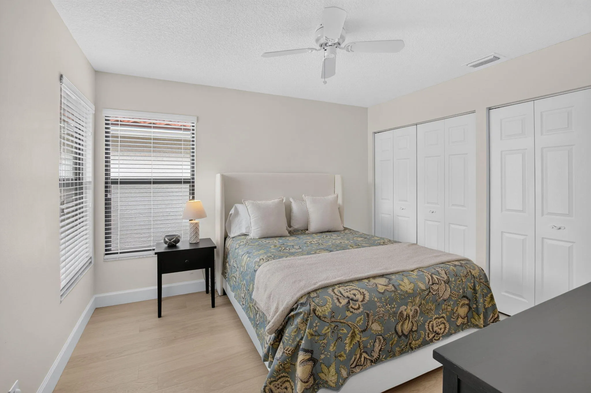 SUNNY GUEST BEDROOM WITH DUAL CLOSETS