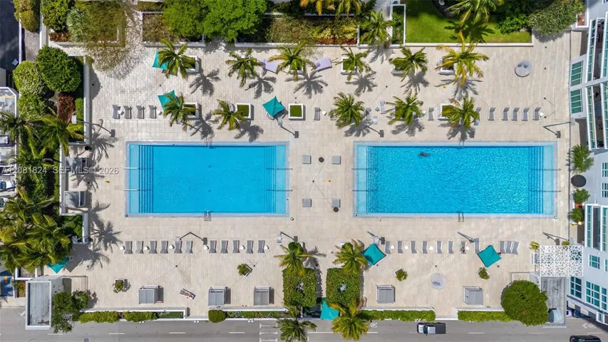 Spacious pool deck with two resort style pools and jacuzzi and BBQ area