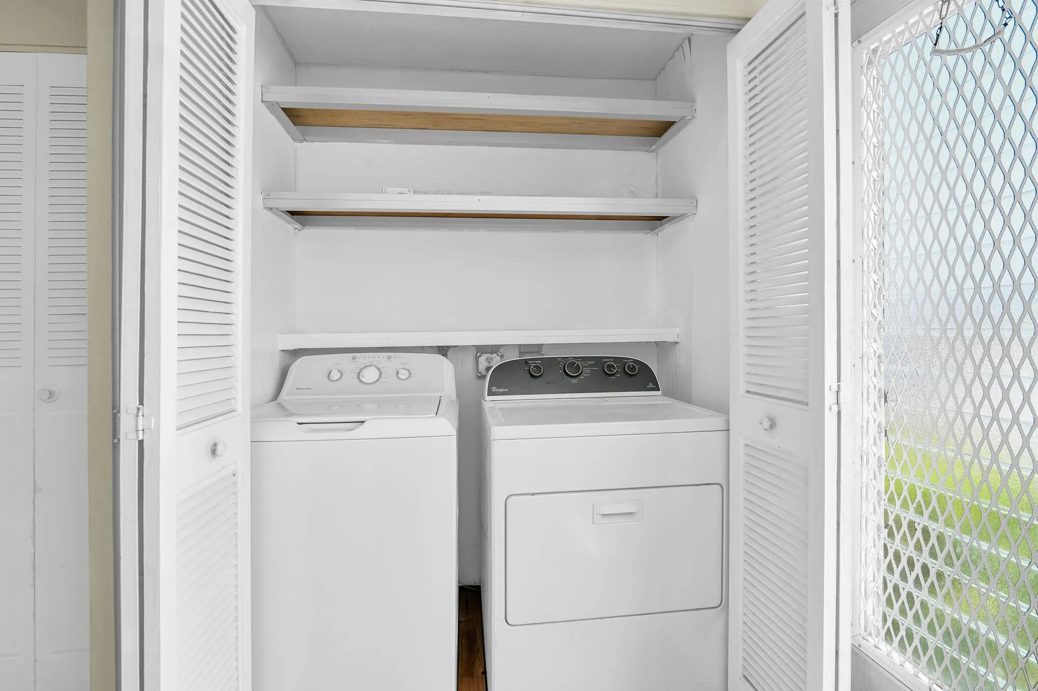 Dedicated laundry closet featuring a top-load washer and front-load dryer