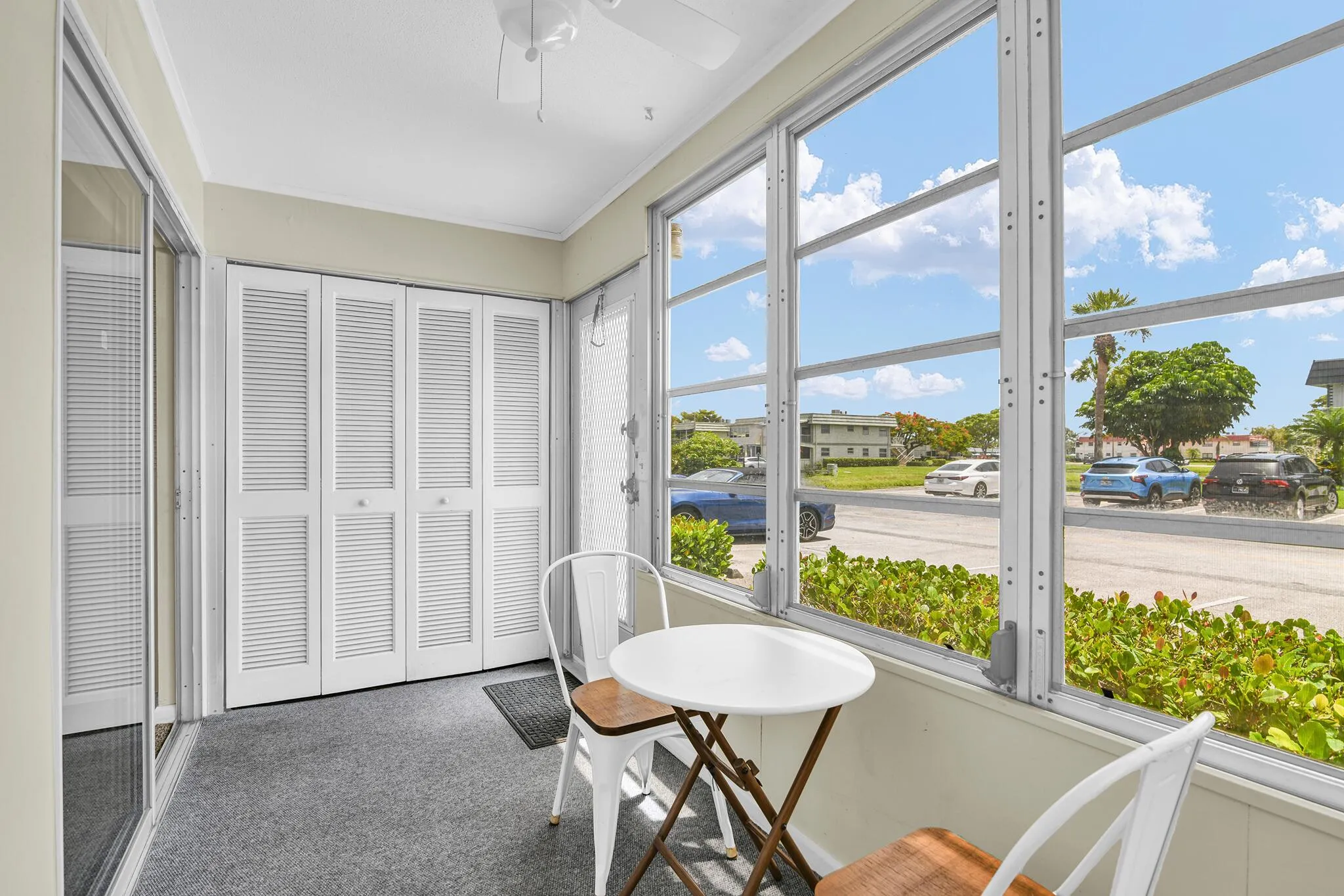 Enclosed sunroom featuring multiple large windows providing abundant natural light