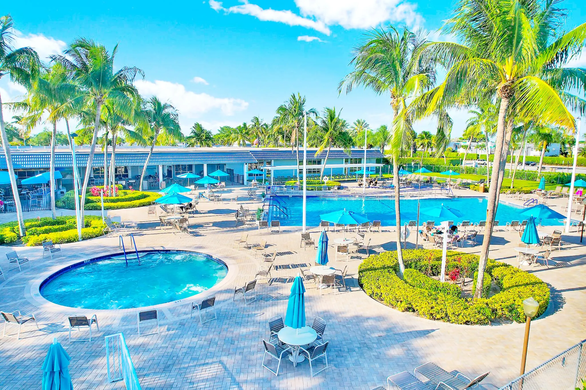 Expansive outdoor recreation area featuring multiple swimming pools, a spa, and extensive patio seating