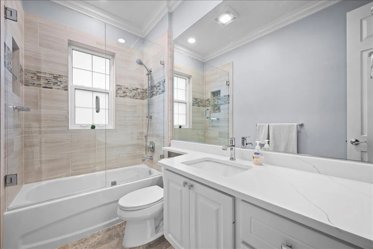 Quartz countertops, custom tile in shower, new glass door