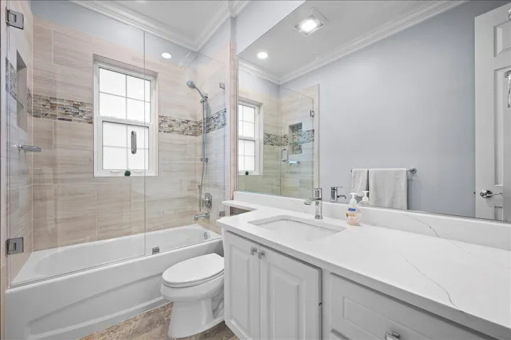 Quartz countertops, custom tile in shower, new glass door