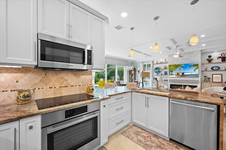 Completely customized kitchen, adding counter space, high end pull out drawers and waterfall countertops