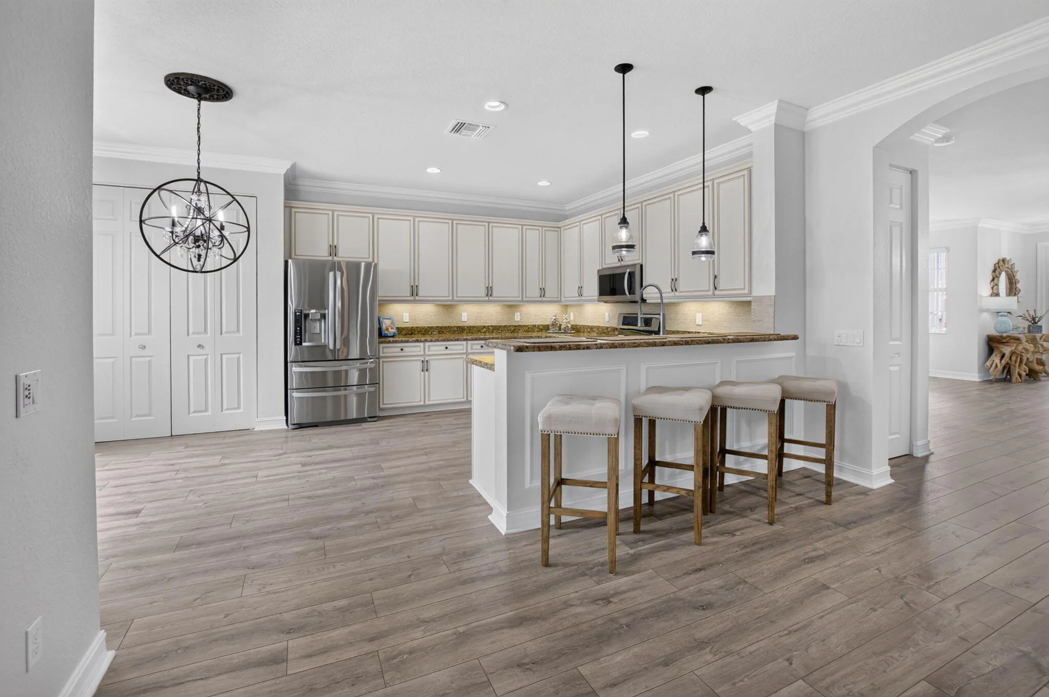 Kitchen Opens to Family Room & Foyer Arch