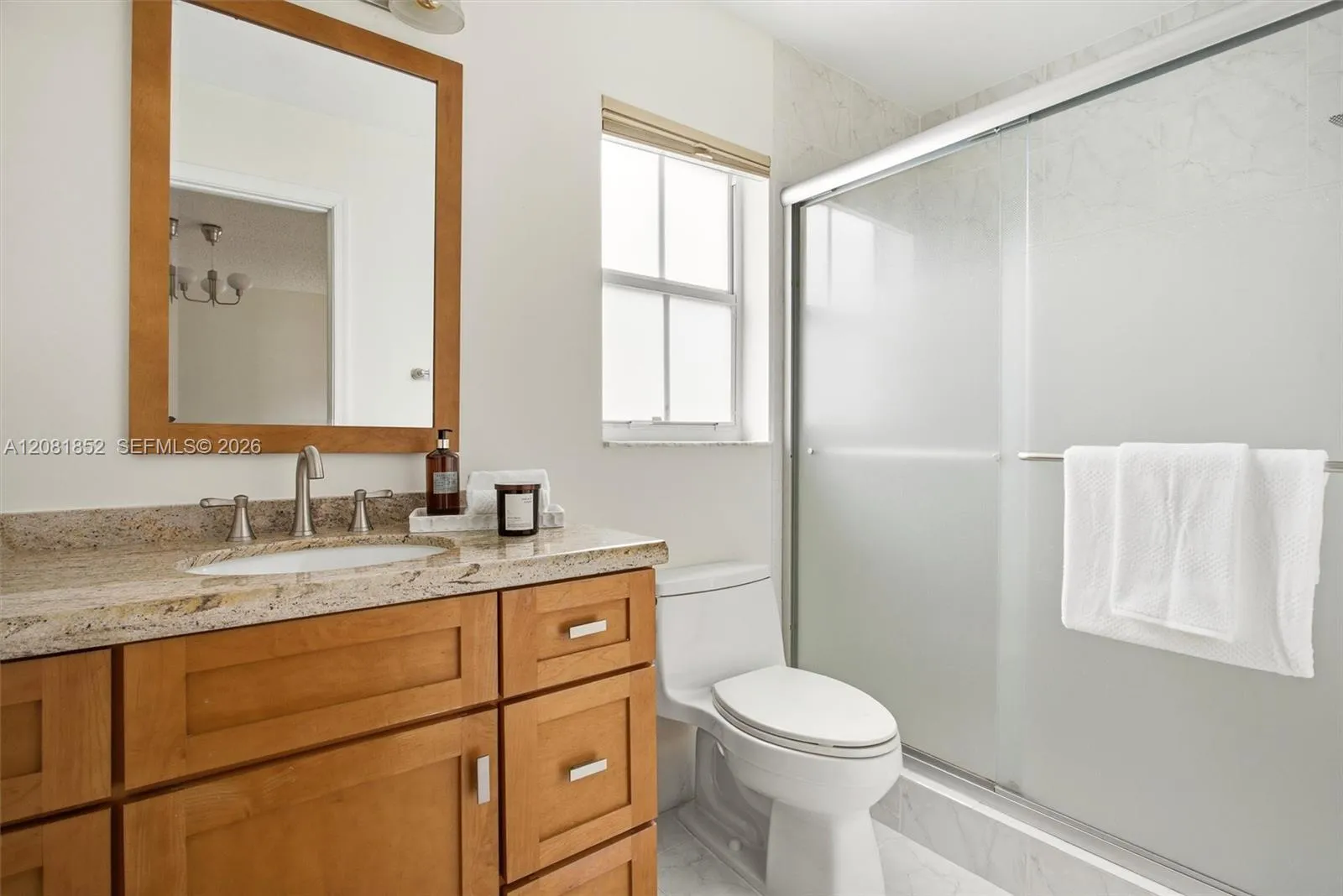 Tastefully finished bathroom with vanity and tiled shower.