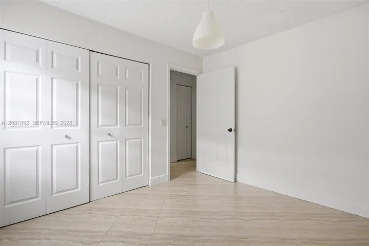Versatile secondary bedroom with ample closet space and natural light.