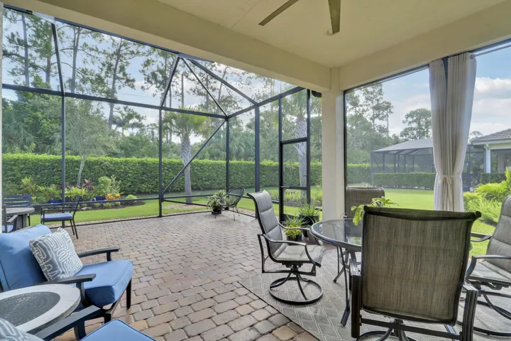 Extended patio and screen enclosure, overlooking beautiful private garden.