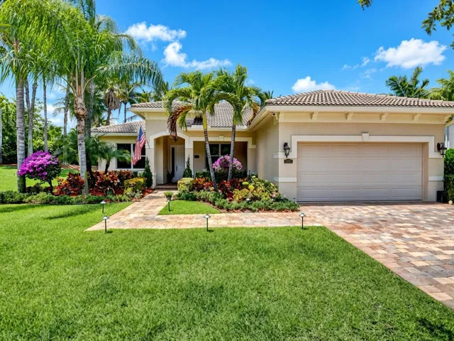 Mediterranean-style exterior with a tile roof, stucco finish, and an integrated garage