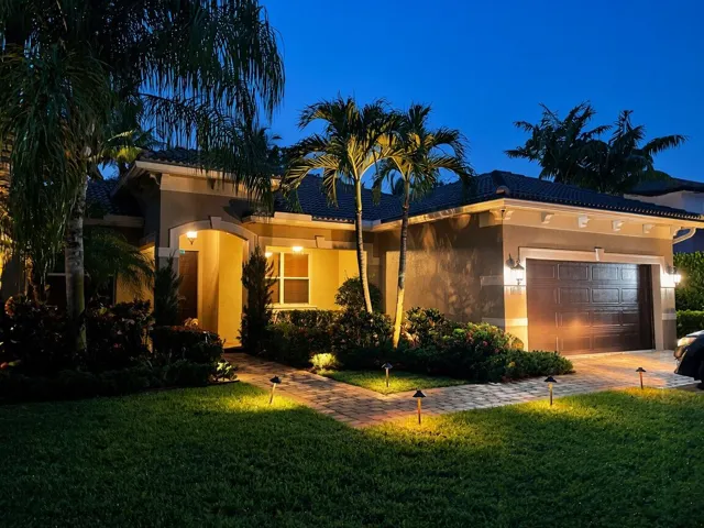 Mediterranean-style exterior with a tile roof, stucco finish, and an integrated garage