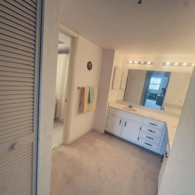 Primary dressing area with 2 walk-in closets.
