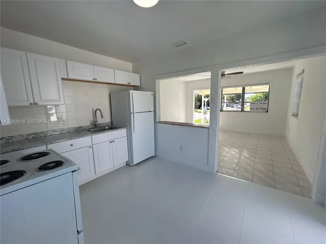 New Kitchen White Cabinetry, New Countertops, New Tile Backsplash, and New Large-Format Floor Tile