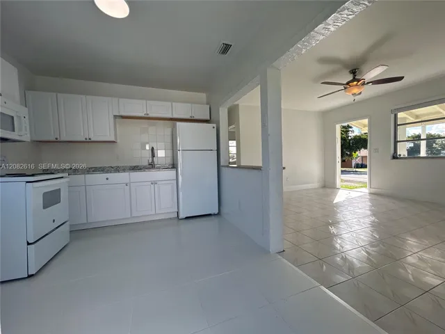 New Kitchen White Cabinetry, New Countertops, New Tile Backsplash, and New Large-Format Floor Tile