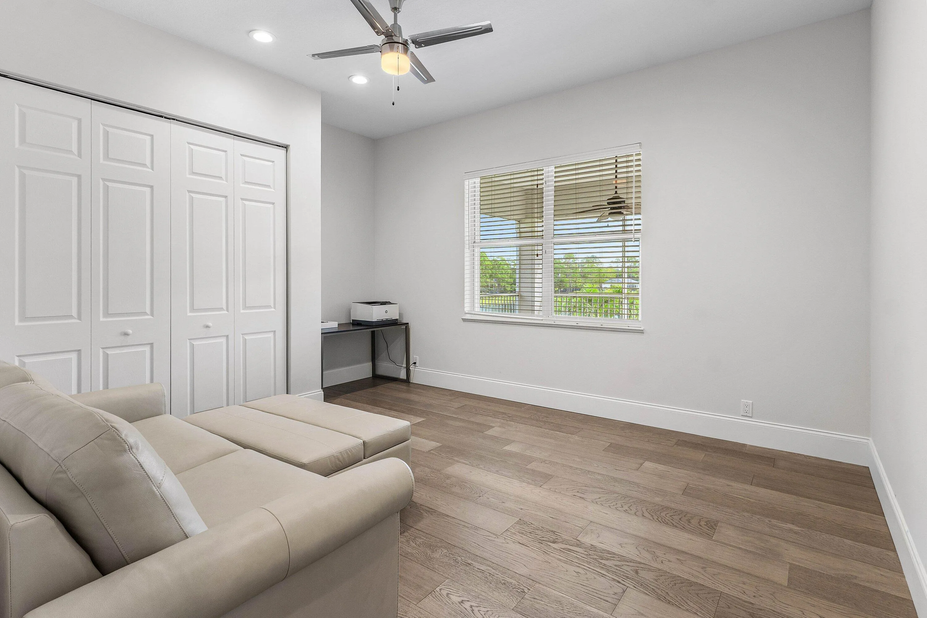 Wood-finish flooring, recessed lighting, and a ceiling fan with integrated lighting