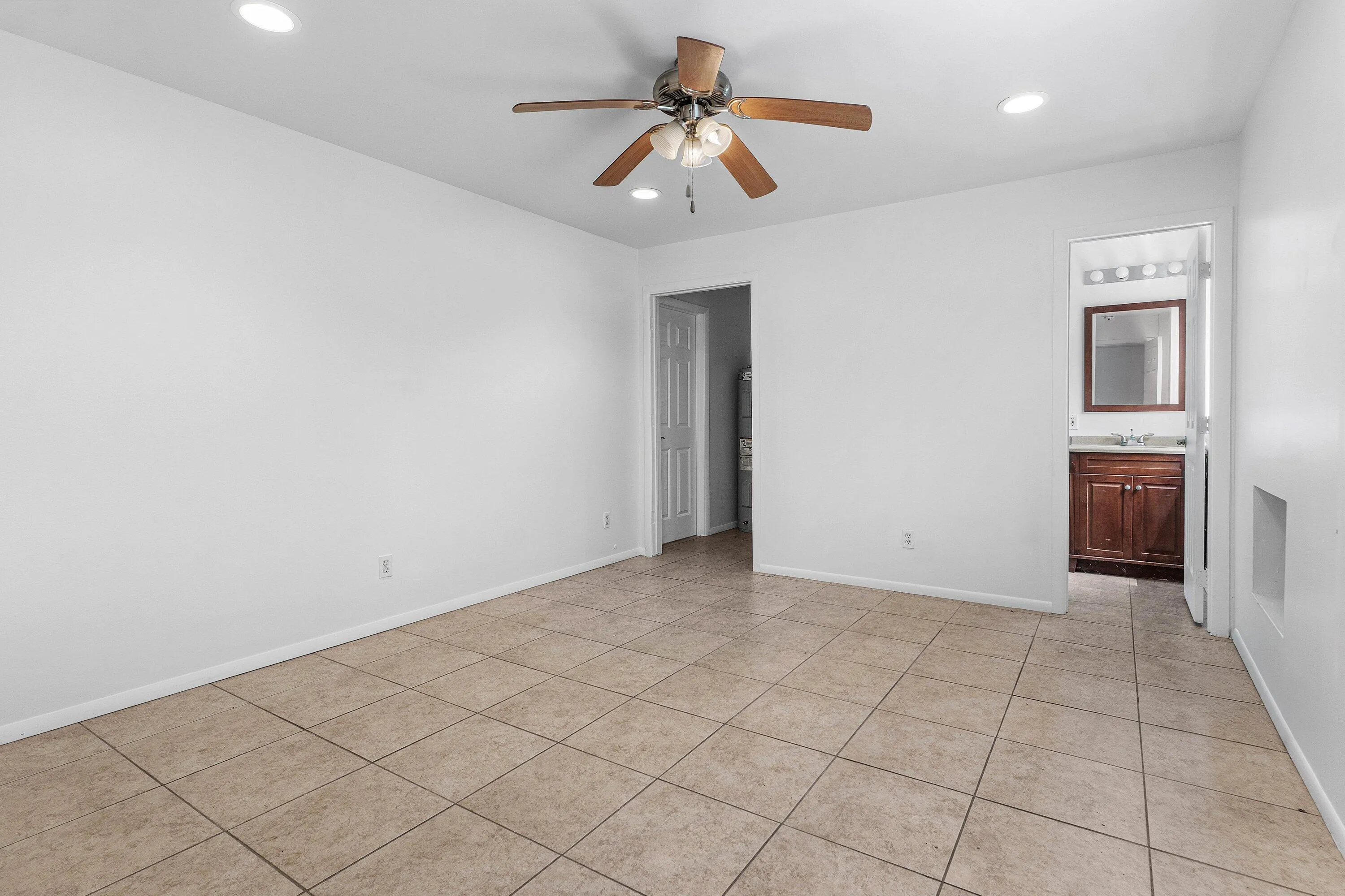 Tile flooring, recessed lighting, and a ceiling fan