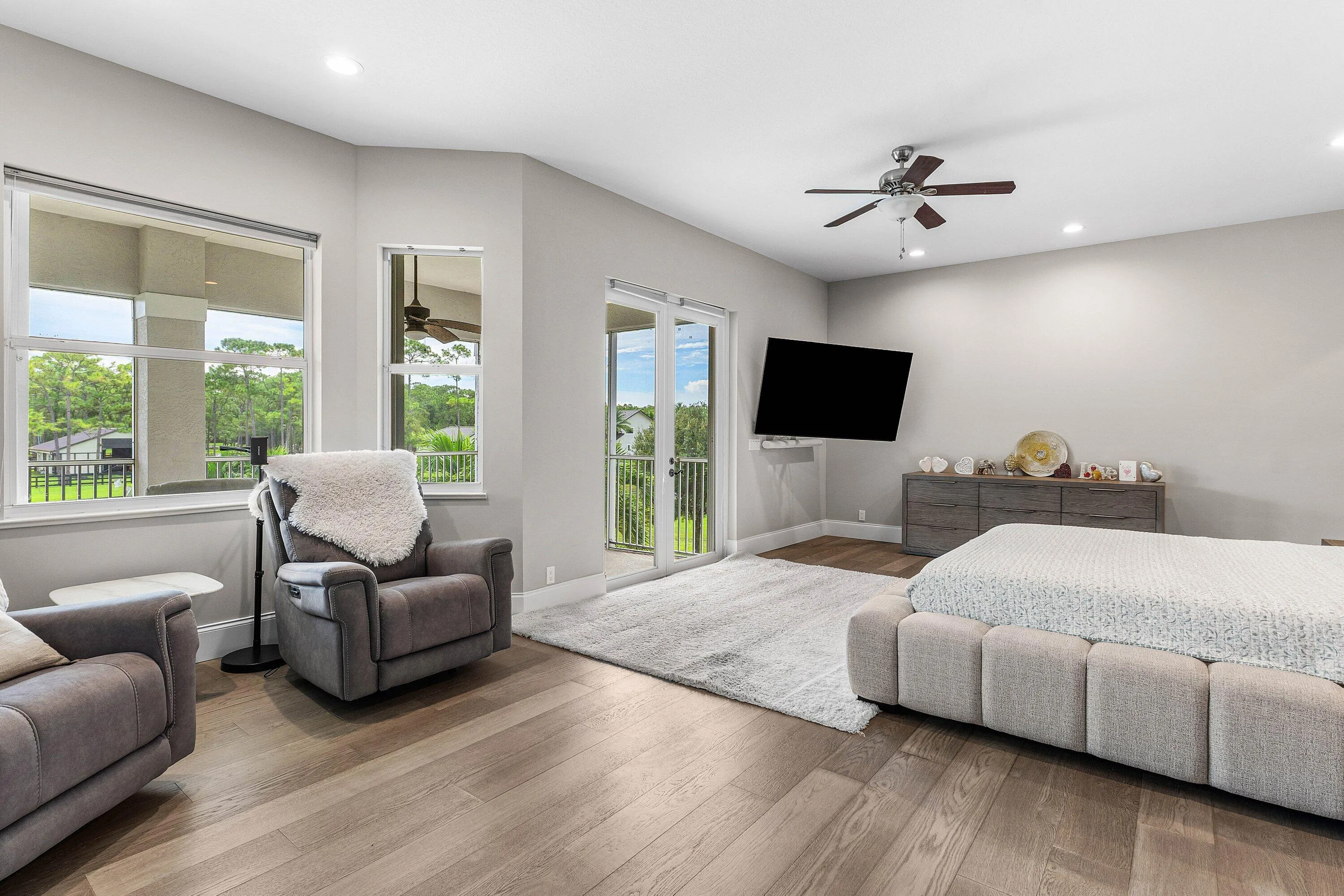 Spacious Master Bedroom featuring wood-finish flooring, recessed lighting, access to the screen in Balcony and super bright