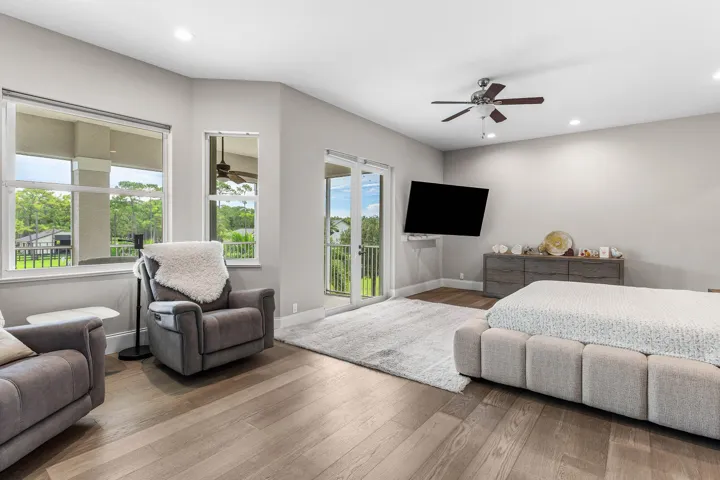 Spacious Master Bedroom featuring wood-finish flooring, recessed lighting, access to the screen in Balcony and super bright