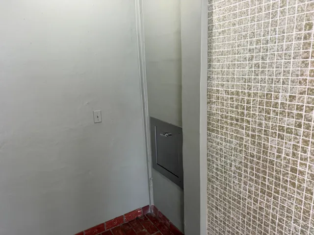 Trash chute next to elevator