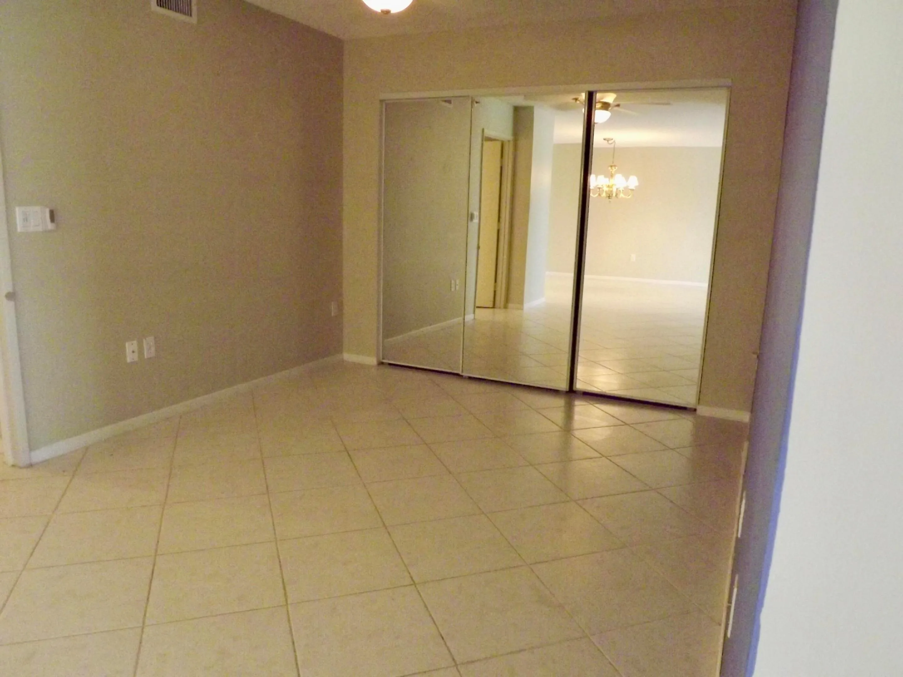 den/home office with large closet for additional storage