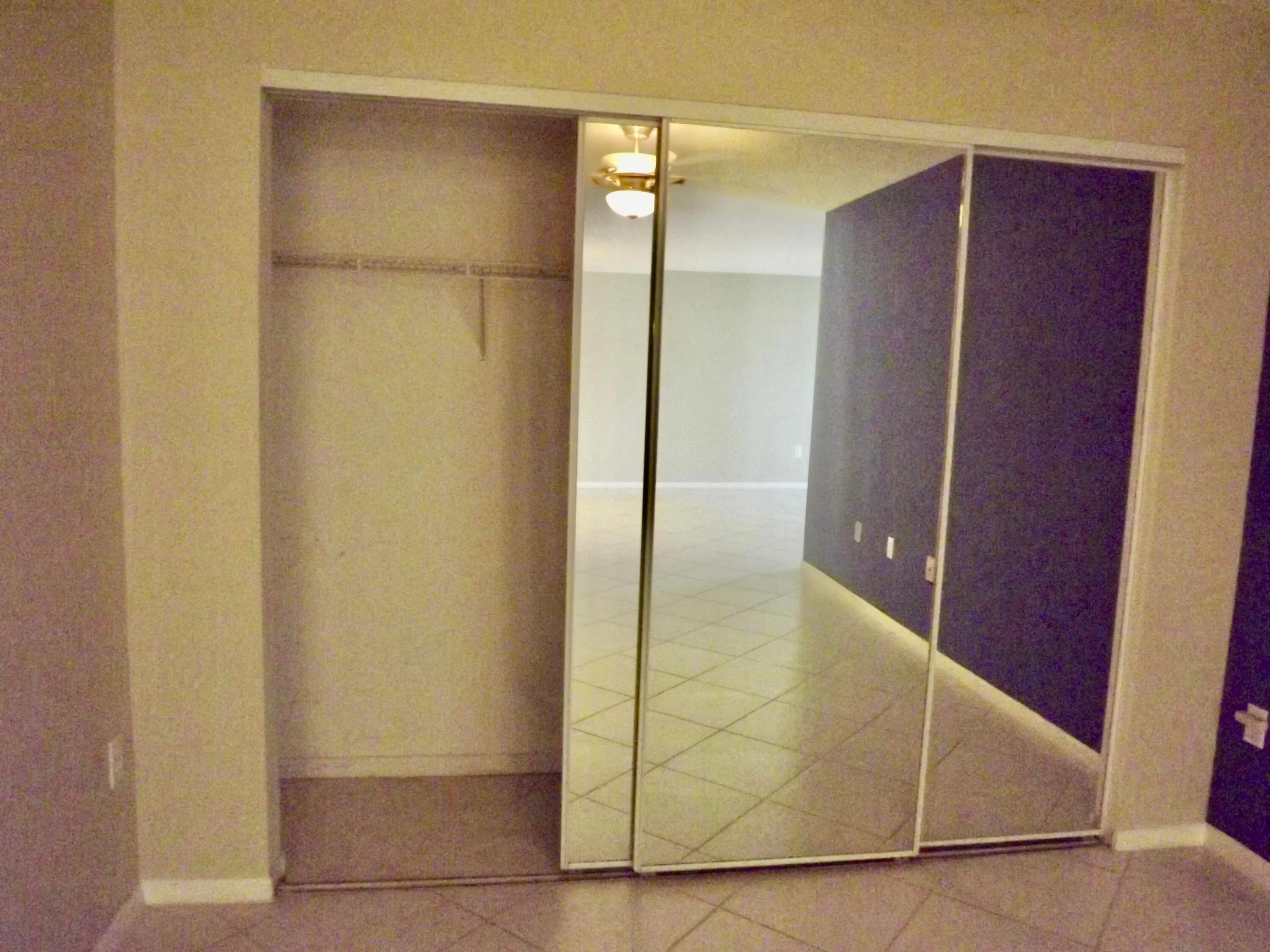 den/home office with large closet for additional storage