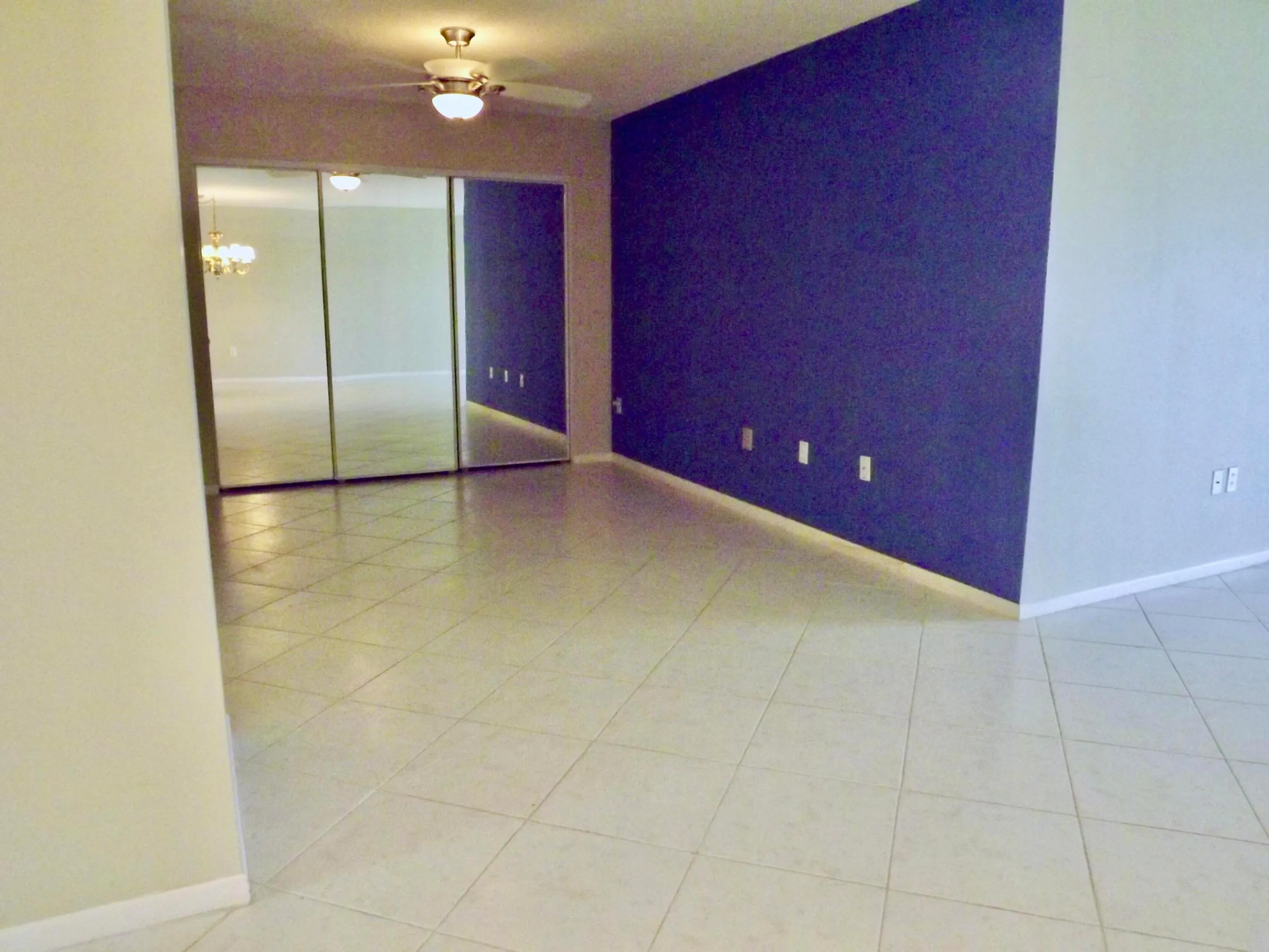 den/home office with large closet for additional storage