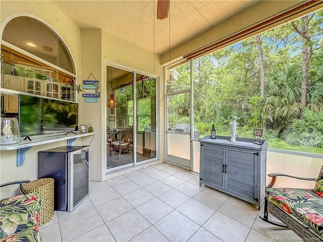 SCREENED, FAN, PASS THROUGH FROM KITCHEN TO ENJOY, 2 SLIDERS ONE TO KITCHEN AND LIVINGROOM , ALL TILED.