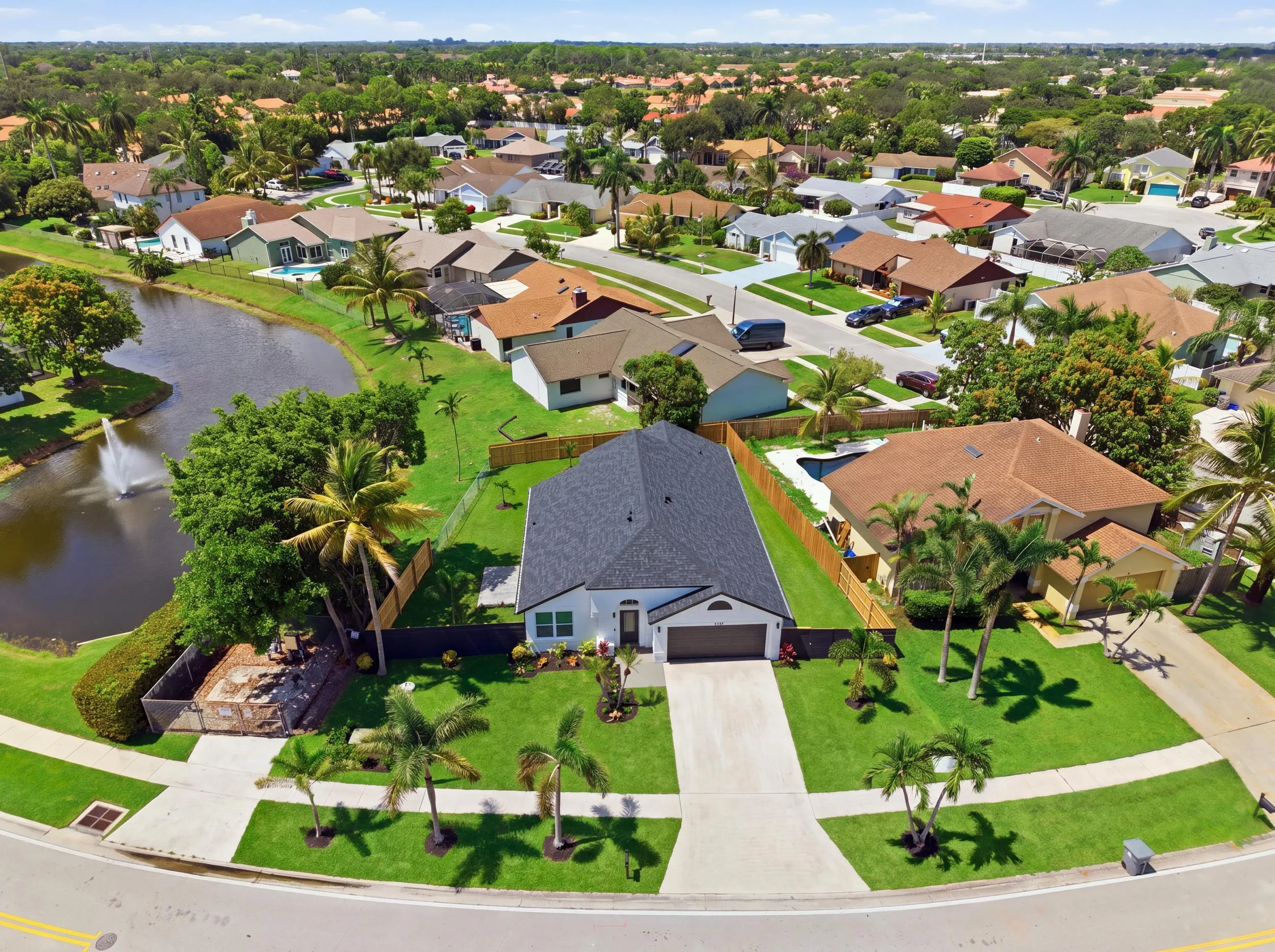 Single-story residence with a dark shingle roof, attached two-car garage, and a concrete driveway