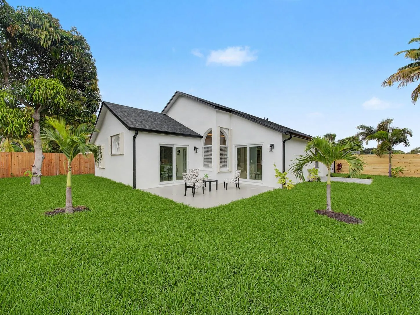Expansive grassy yard with a concrete patio