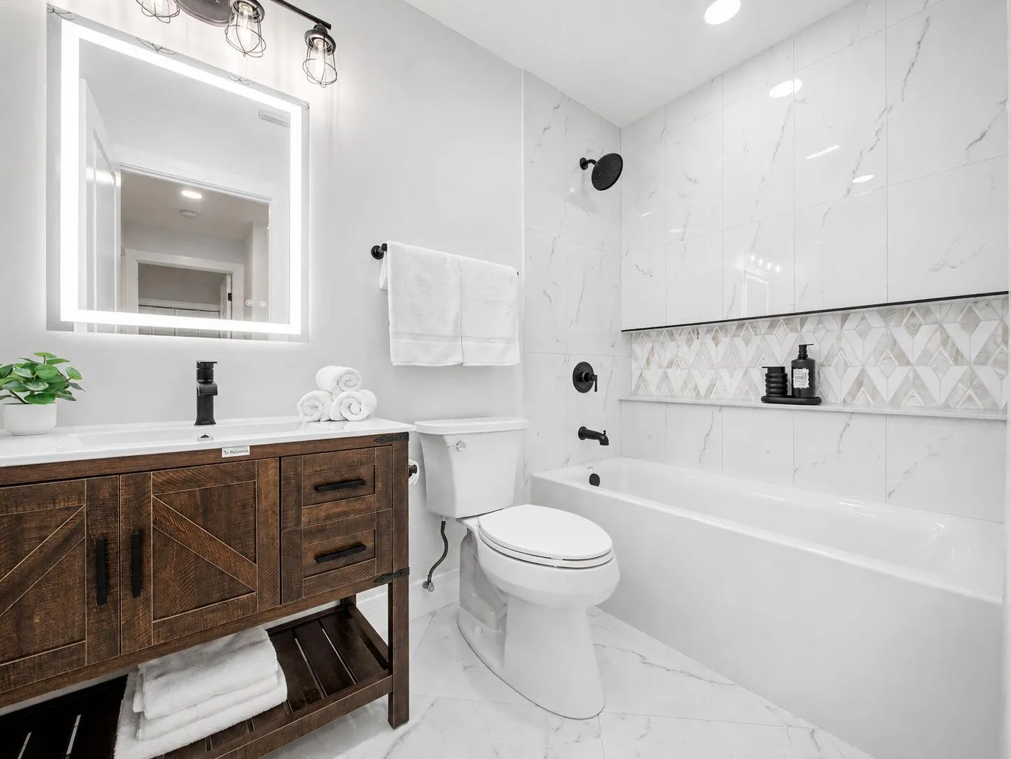Custom dark wood-finish vanity with a white rectangular sink and matte black faucet