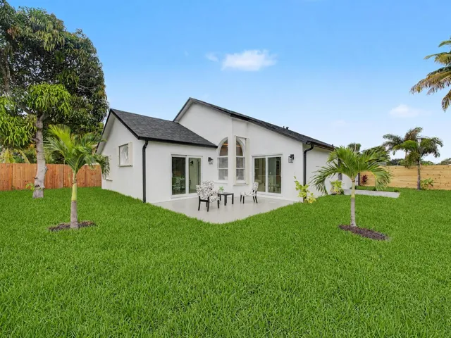 Expansive grassy yard with a concrete patio
