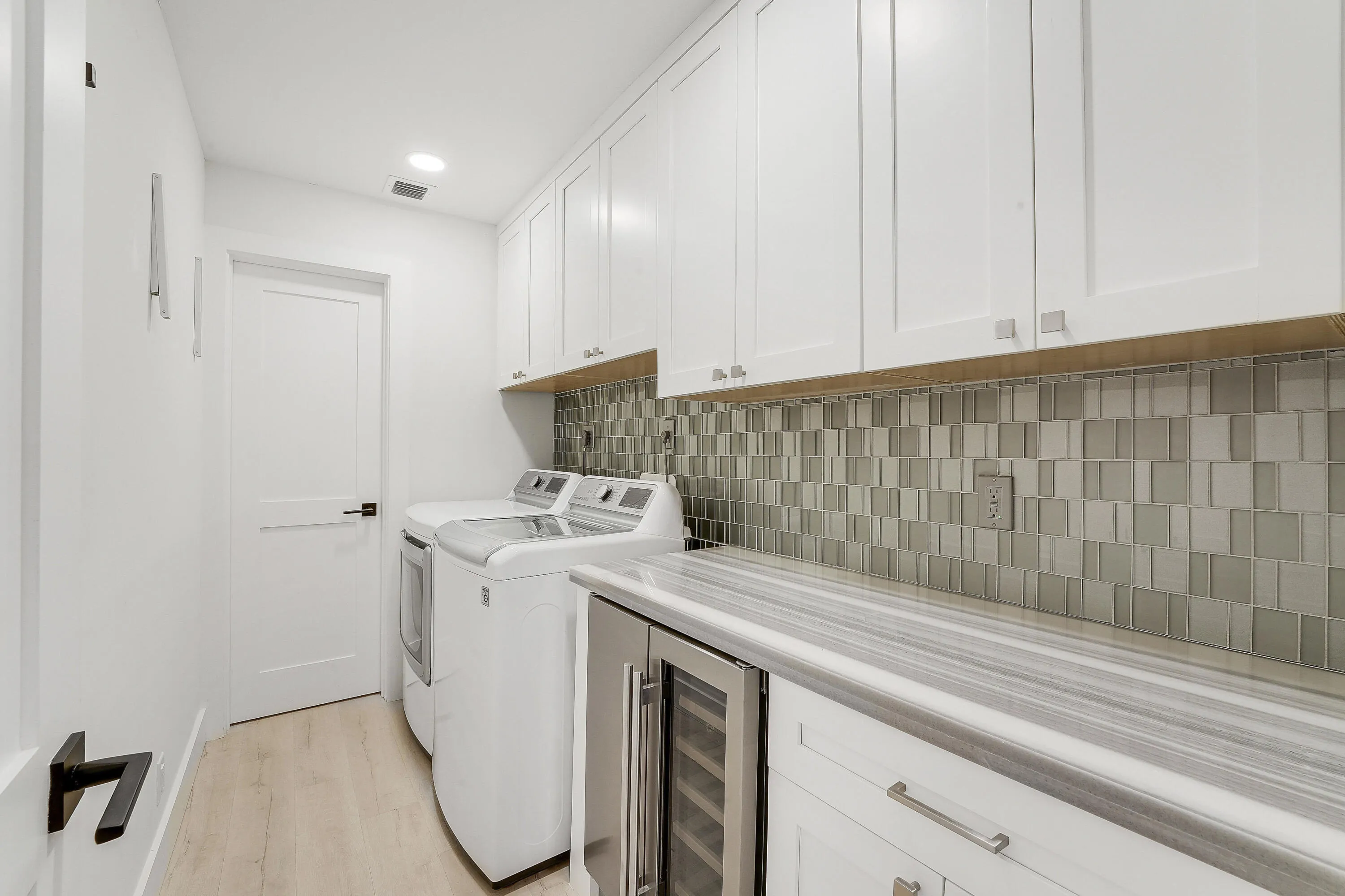 Located inside of the main home. Wine fridge and utility closet.