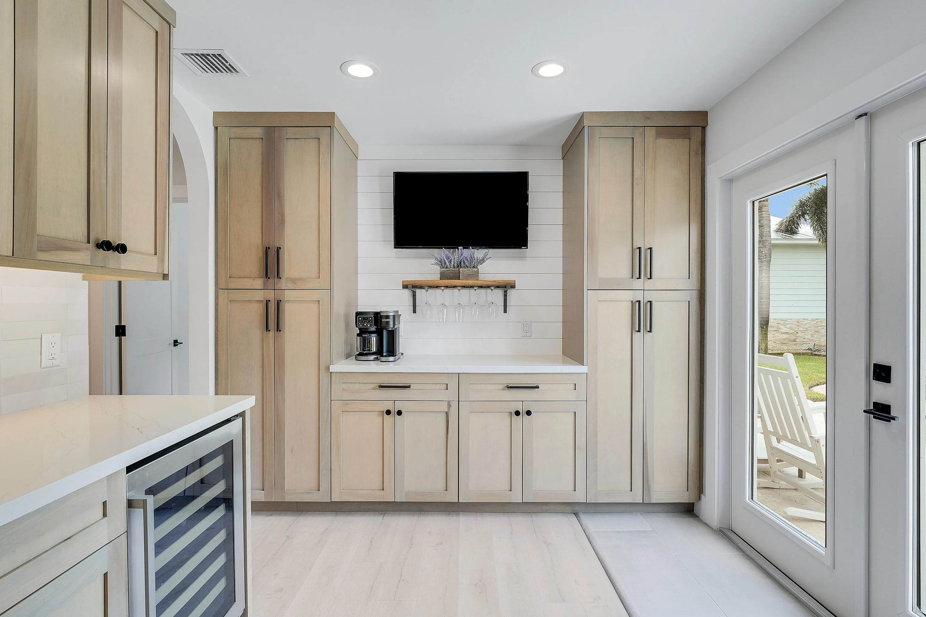 Pantry with built in bar set up with wine fridge