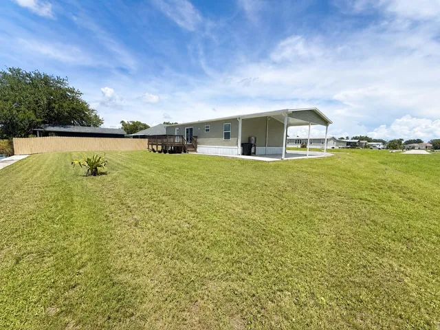 Sunny Backyard with Manufactured Home an