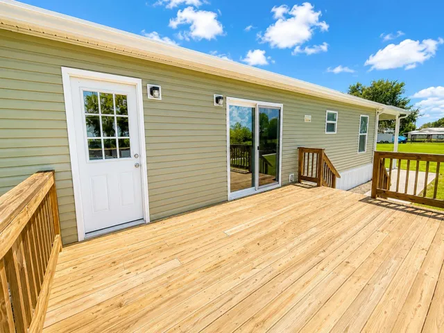 Sunny Wooden Deck and Sage Green House