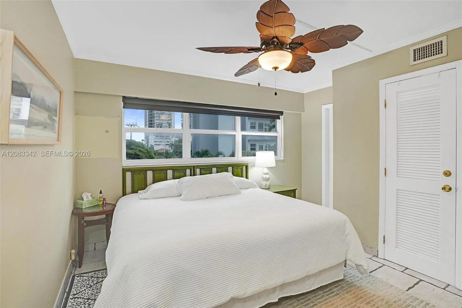 A light bright bedroom with remote controal ceiling fan