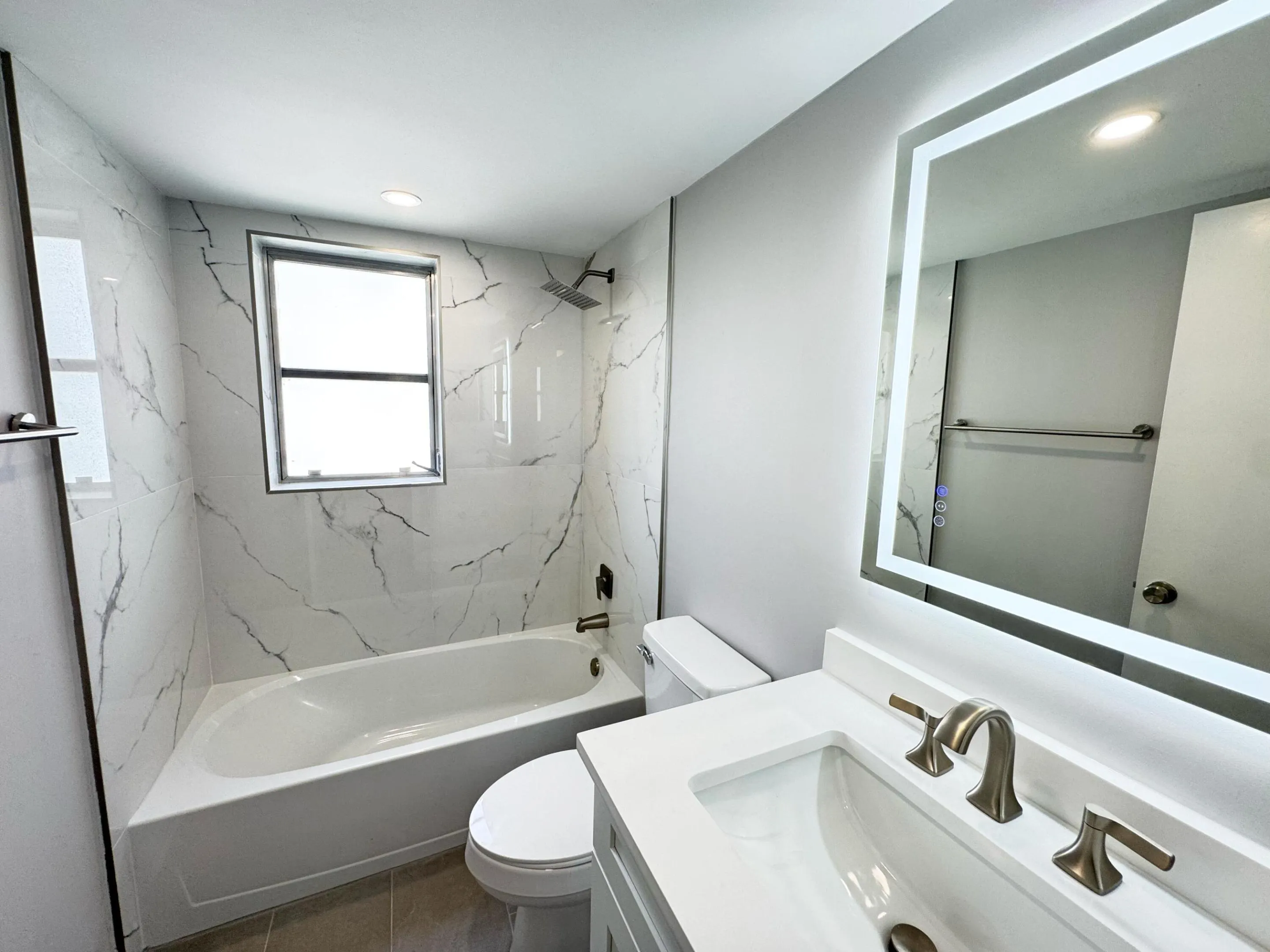 new tub and tile surround and flooring, vanity and sink