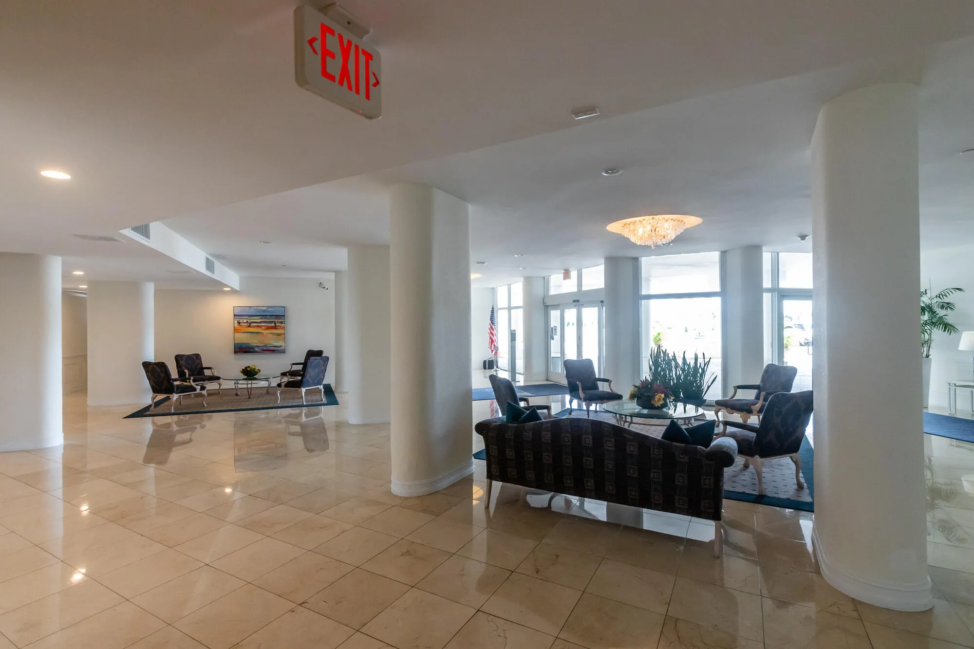 Polished tile flooring, recessed lighting, and expansive window walls create a bright interior