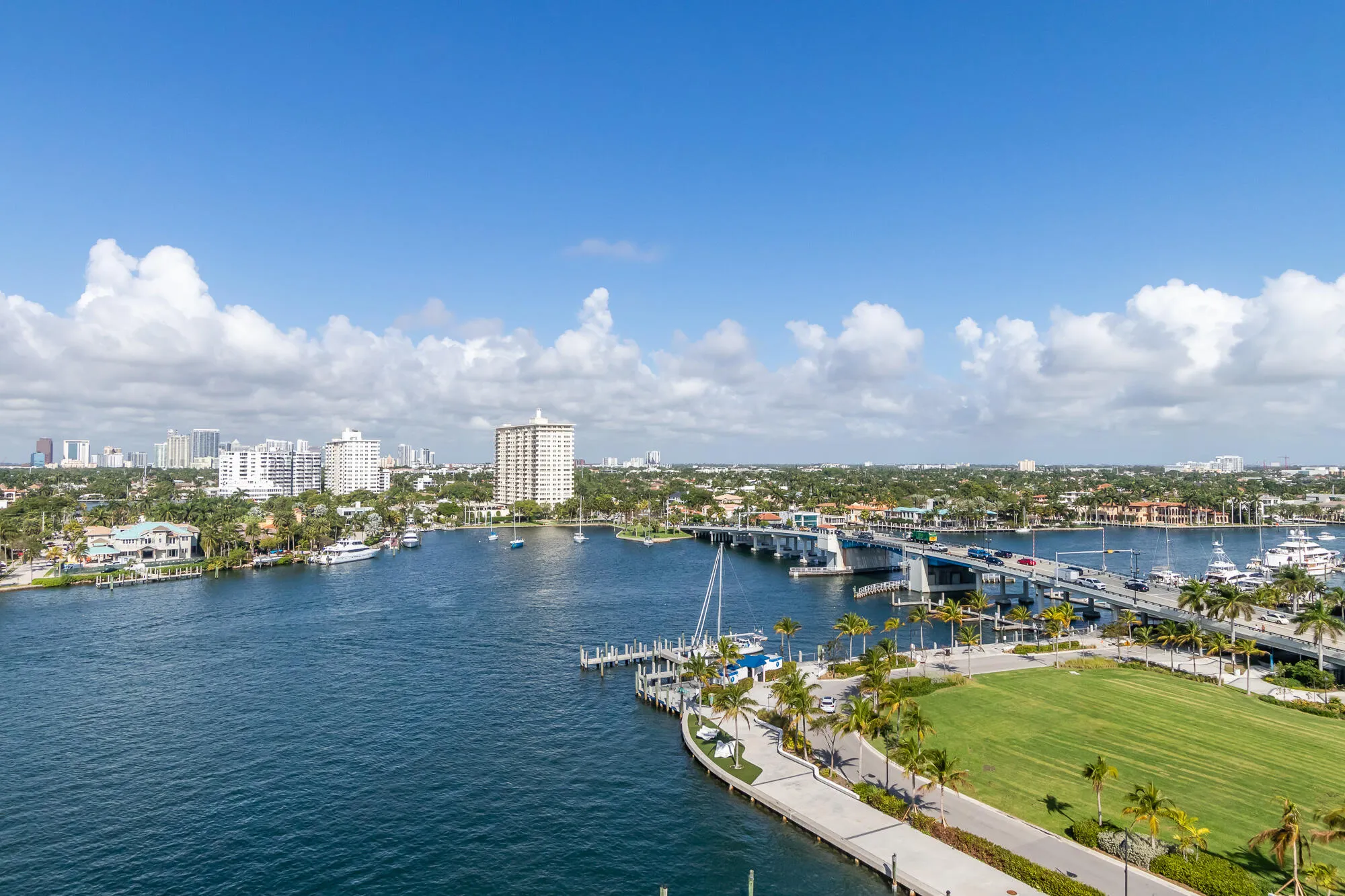 Expansive water frontage with multiple boat slips and a manicured green space