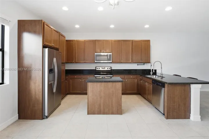 Kitchen - Notice Stainless Steel Appliances and Chef's Center Aisle