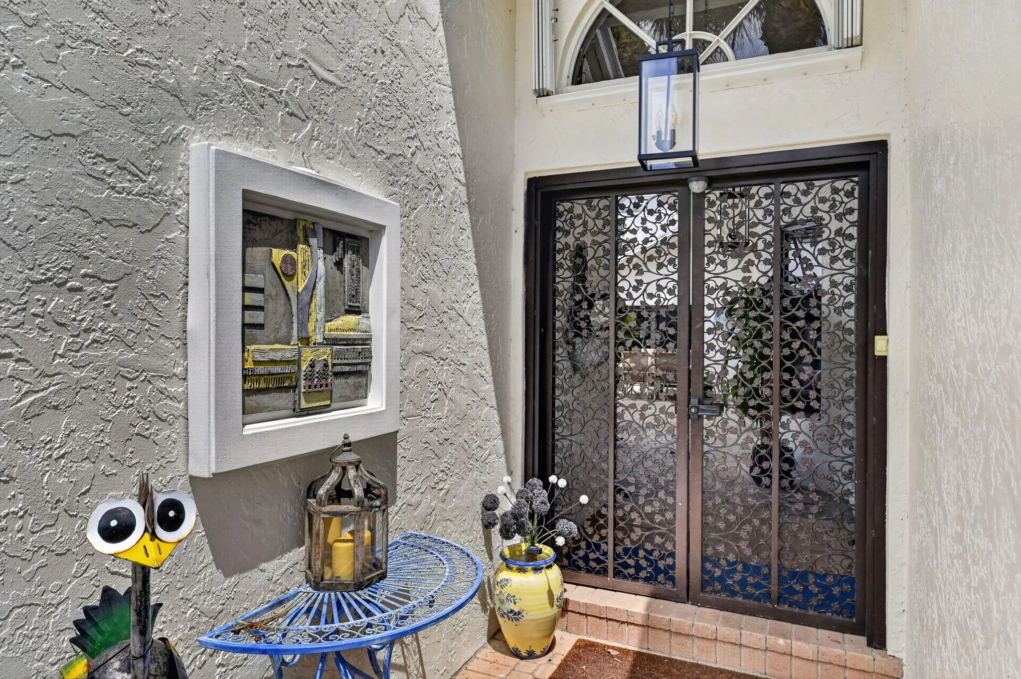Decorative iron doors lead to private courtyard