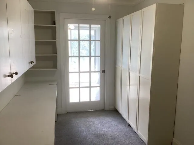 set up as office with door leading to patio