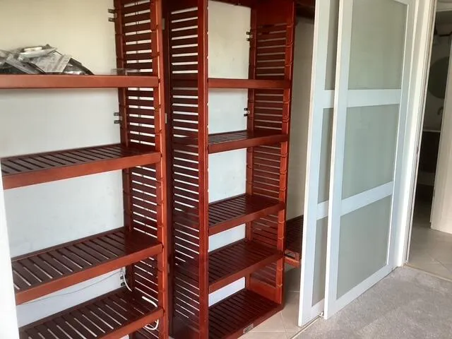 Interior shelving designed with red wood built-ins