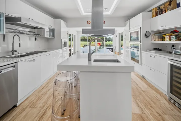 Elegant chef-inspired kitchen featuring a grand center island, sleek cabinetry, and refined modern finishes.
