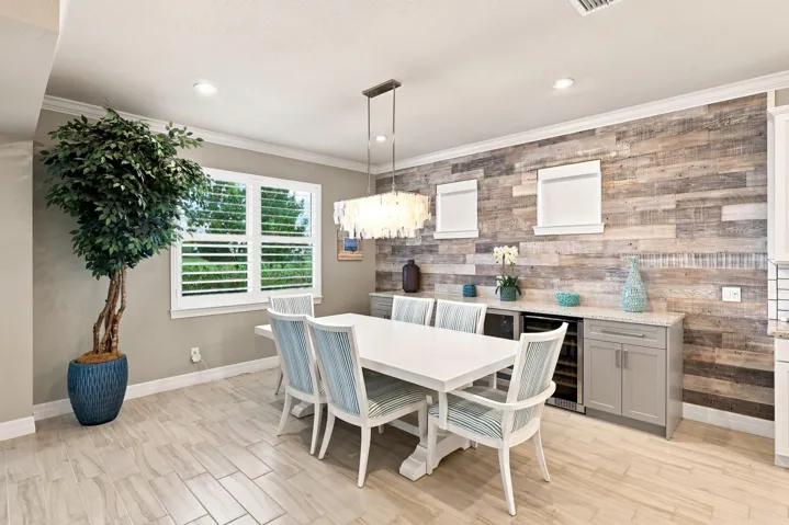 Dining room with extended cabinets & wine cooler along accented wall