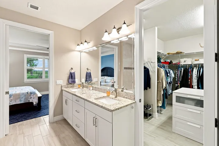 Primary bathroom with double sinks & large walk in closet